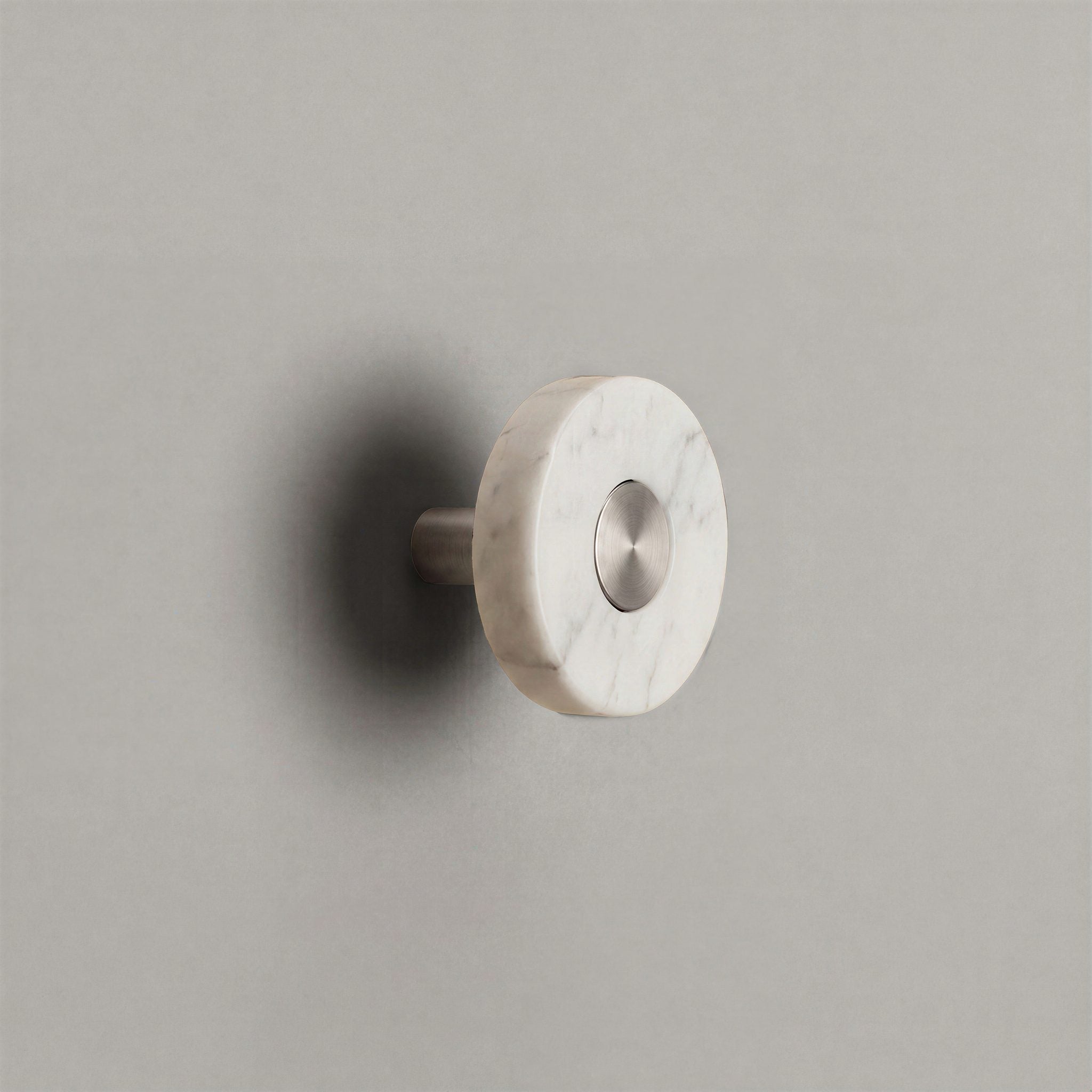 White Marble Ensemble Handle in Knob size with Brushed Steel button detail by Sloan Roberts.