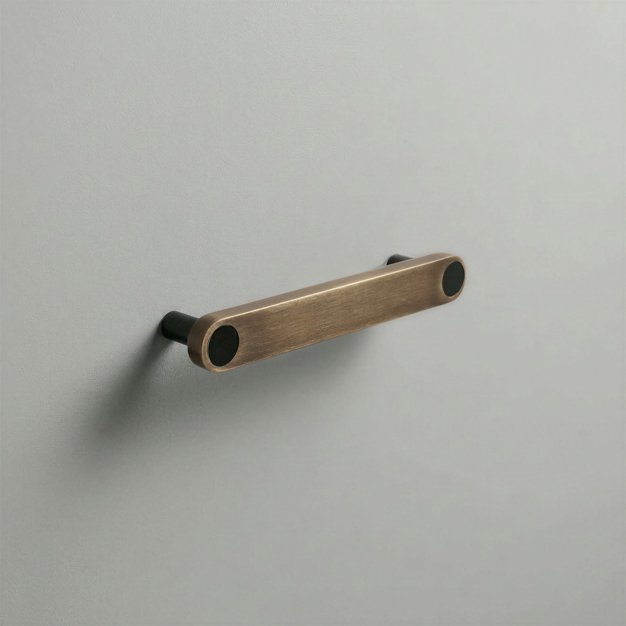 Aged Bronze Ensemble Handle in 128mm Centres with Matte Black button detail by Sloan Roberts.