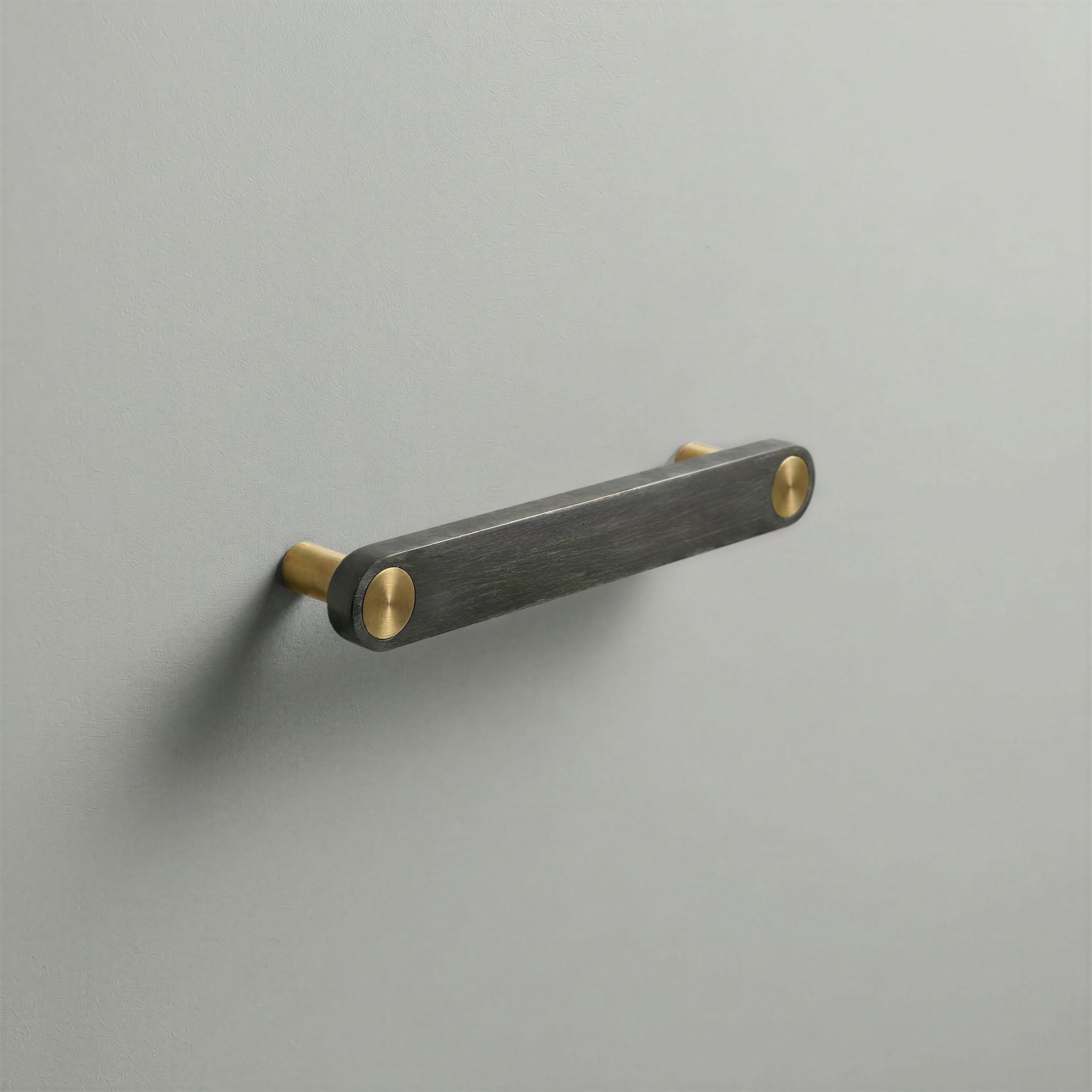 Gunmetal Ensemble Handle in 128mm Centres with Brass button detail by Sloan Roberts.
