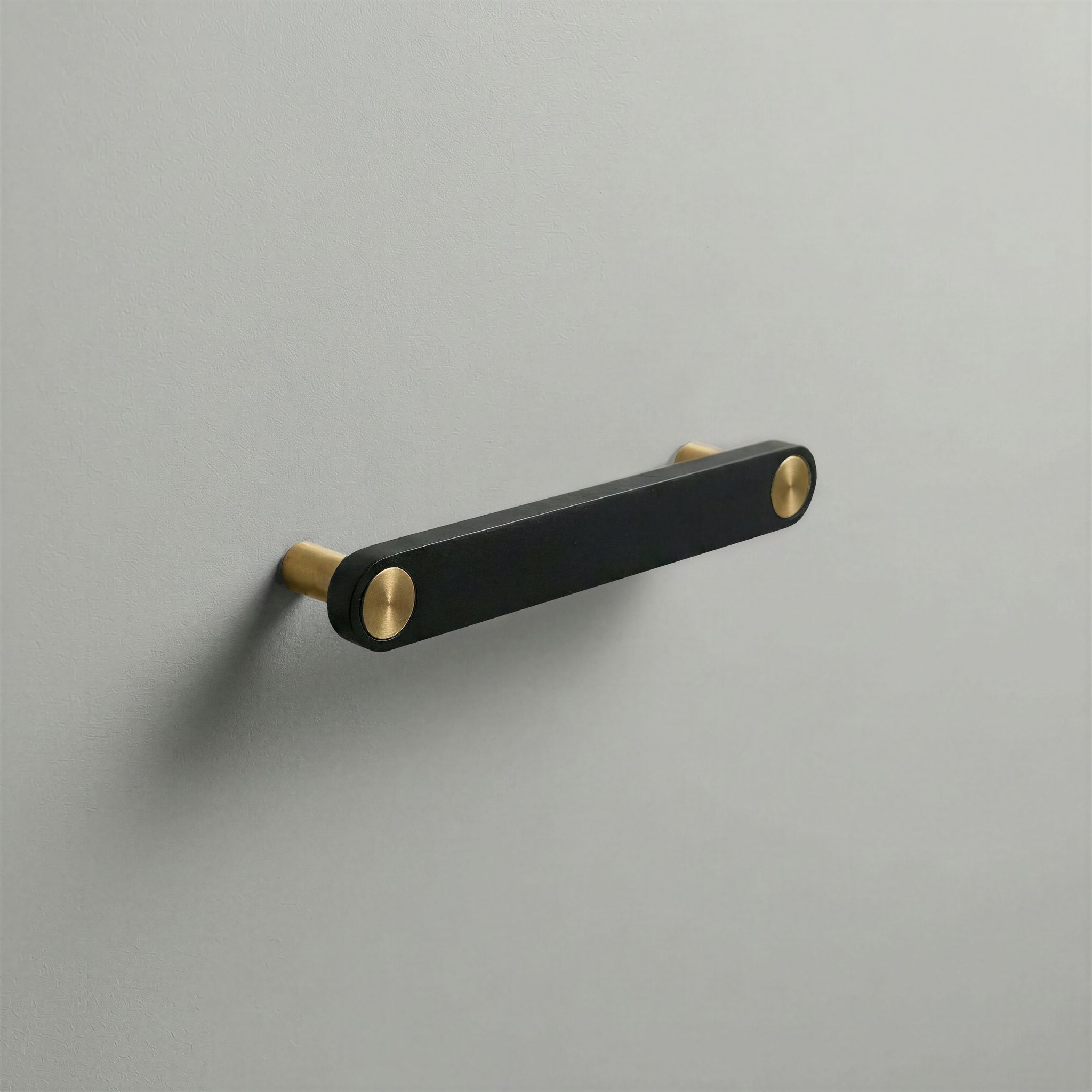 Matte Black Ensemble Handle in 128mm Centres with Brass button detail by Sloan Roberts.
