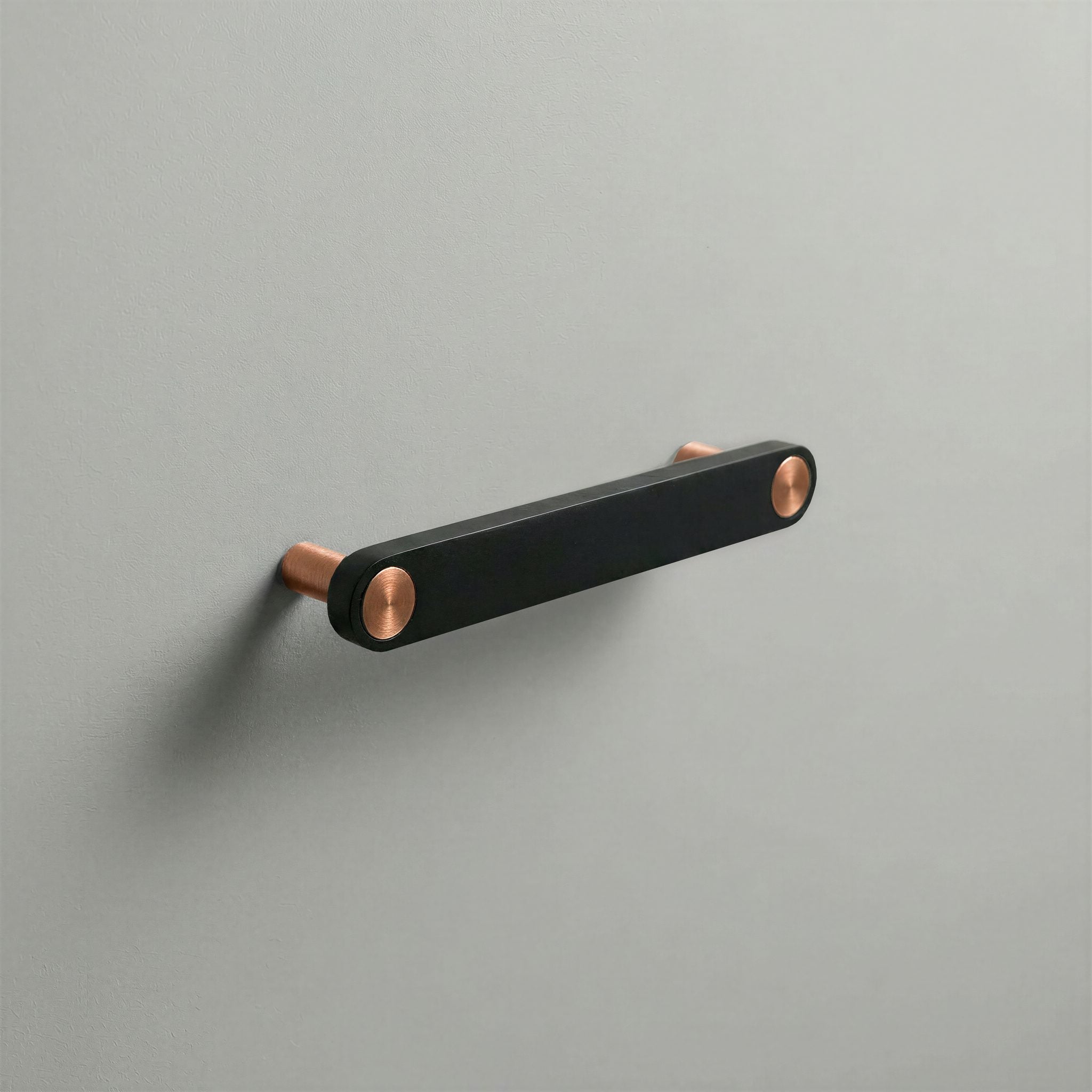 Matte Black Ensemble Handle in 128mm Centres with Brushed Copper button detail by Sloan Roberts.
