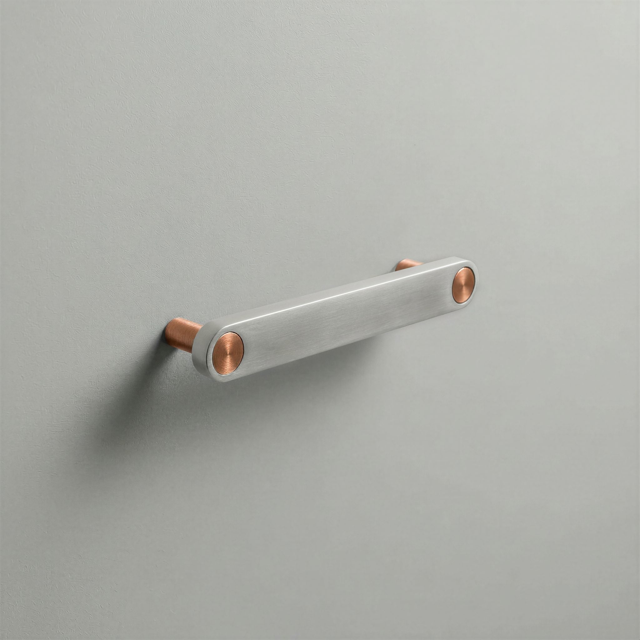Brushed Steel Ensemble Handle in 128mm Centres with Brushed Copper button detail by Sloan Roberts.