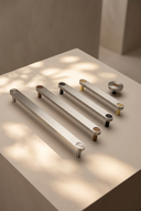 Ensemble Brushed Steel Handle — modular cabinet handle by Sloan Roberts. Cool brushed steel finish, available as knob or bar in four sizes with choice of button detail. Designed and assembled in Melbourne.