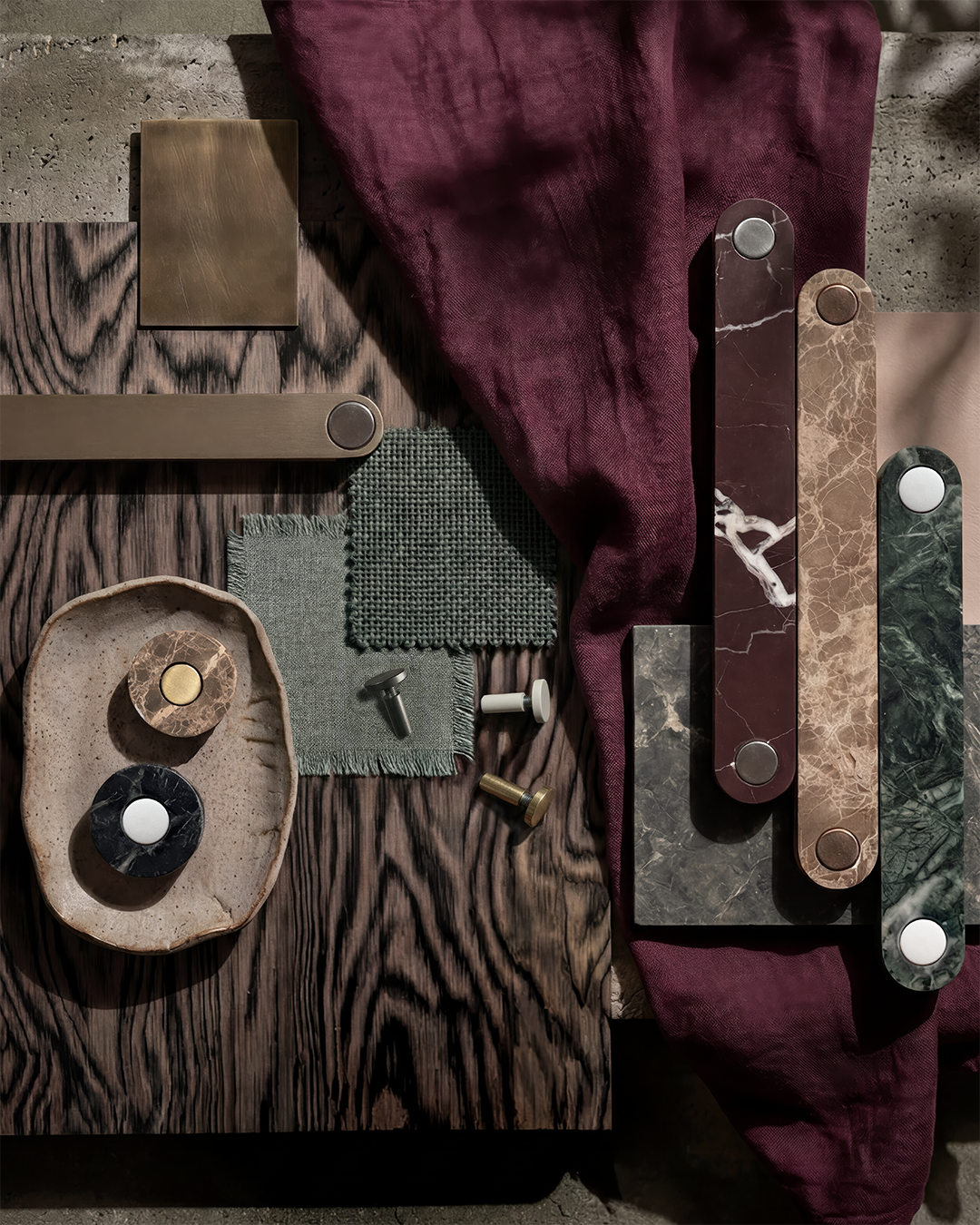 Ensemble handles in metal, timber and marble finishes laid out together