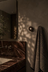 Ensemble Red Marble Hook — modular wall hook by Sloan Roberts. Crafted from Rosso Levanto marble with choice of metallic button detail. Suited to bathrooms, ensuites and wardrobes. Designed and assembled in Melbourne.