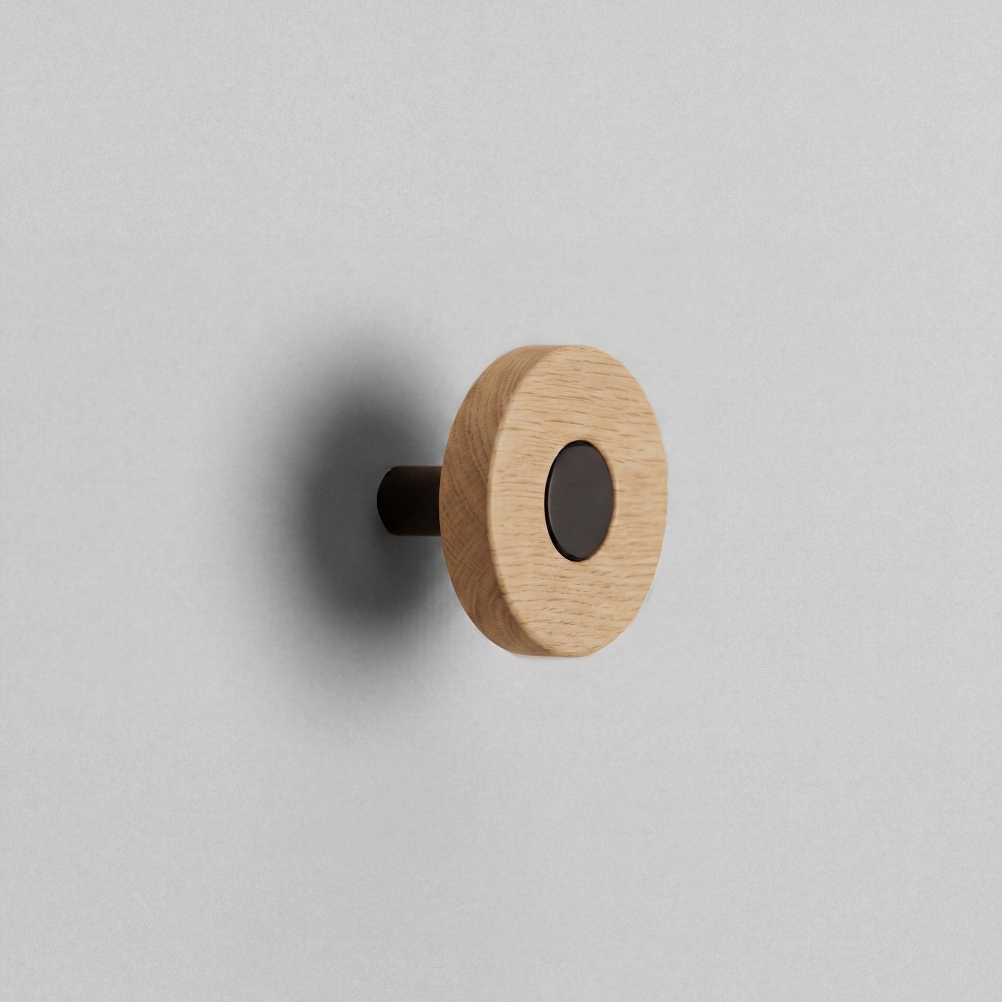 Oak Ensemble Handle in Knob size with Matte Black button detail by Sloan Roberts.