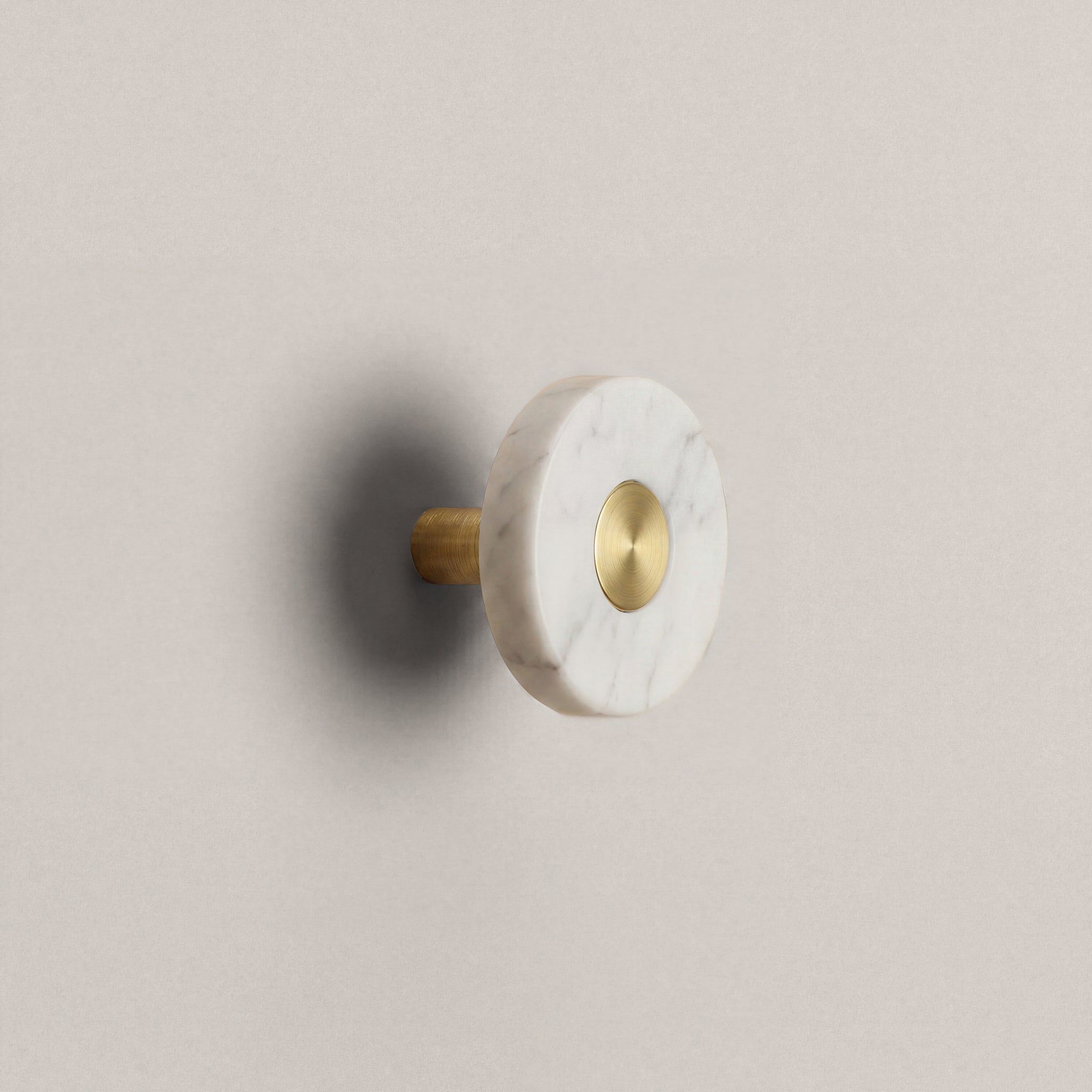 White Marble Ensemble Handle in Knob size with Brass button detail by Sloan Roberts.