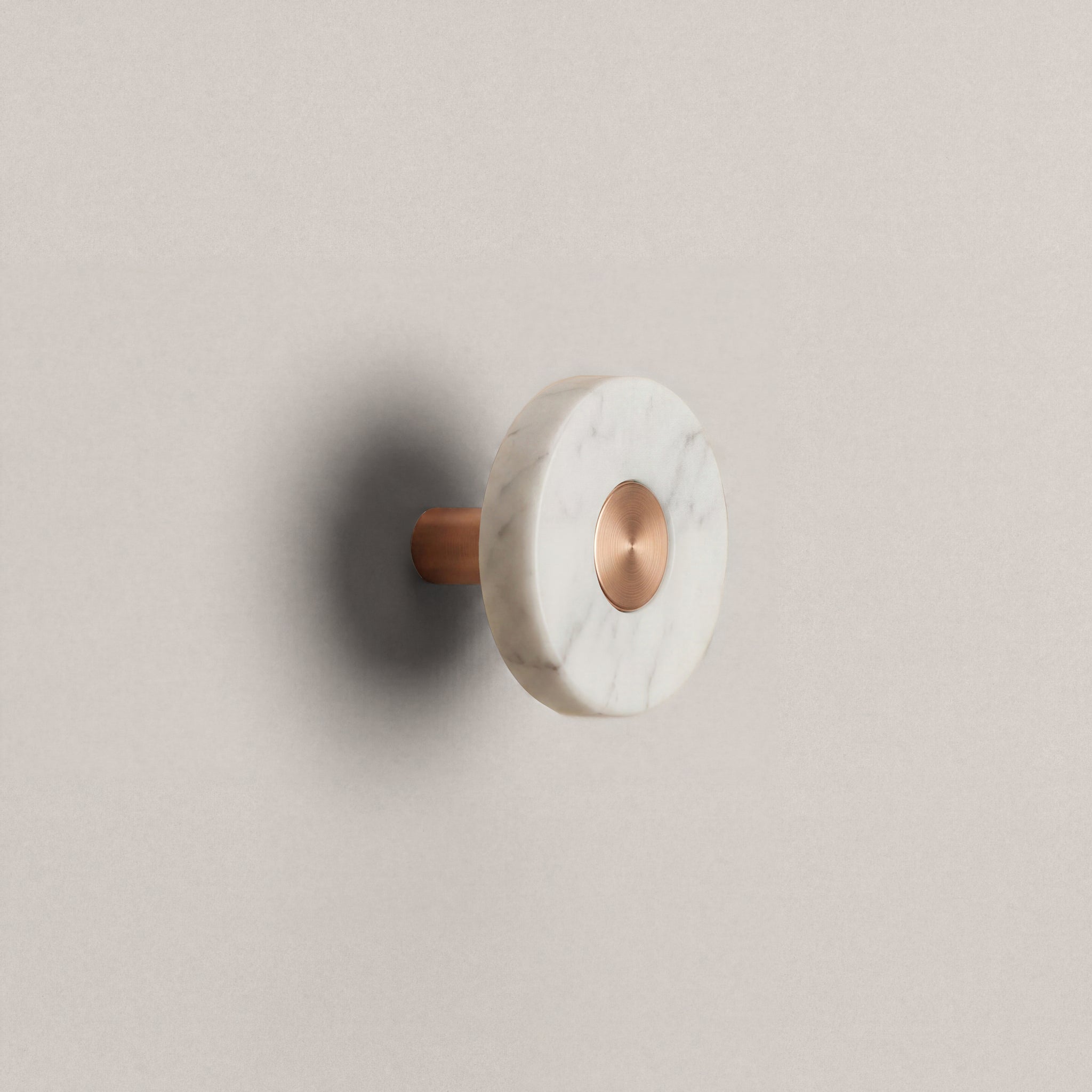 White Marble Ensemble Handle in Knob size with Brushed Copper button detail by Sloan Roberts.