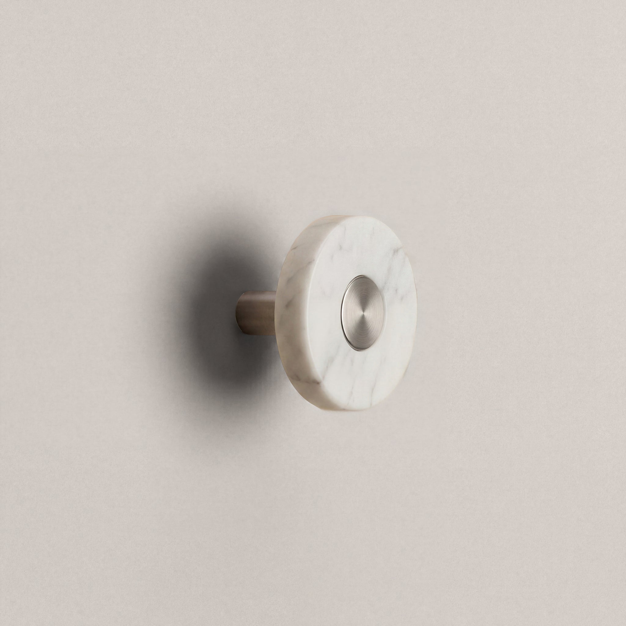 White Marble Ensemble Handle in Knob size with Brushed Steel button detail by Sloan Roberts.