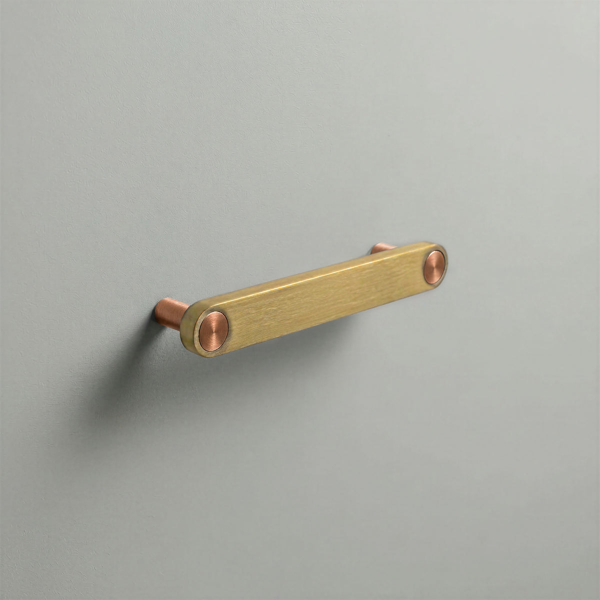 Brass Ensemble Handle in 128mm (5″) Centres size with Brushed Copper button detail by Sloan Roberts.