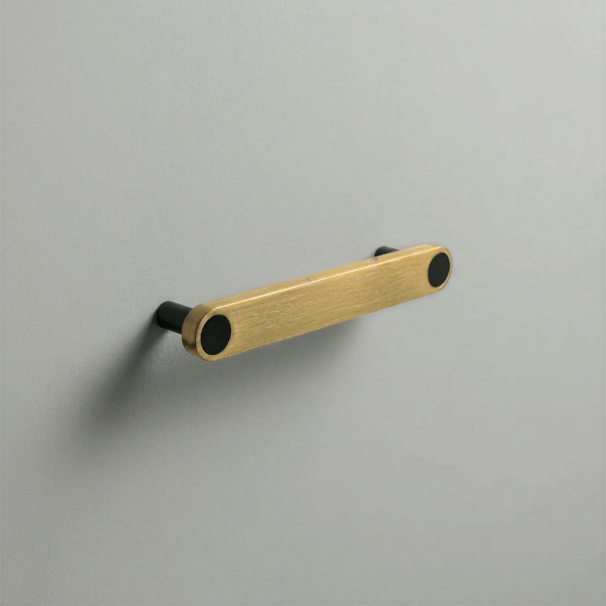 Brass Ensemble Handle in 128mm (5″) Centres size with Matte Black button detail by Sloan Roberts.