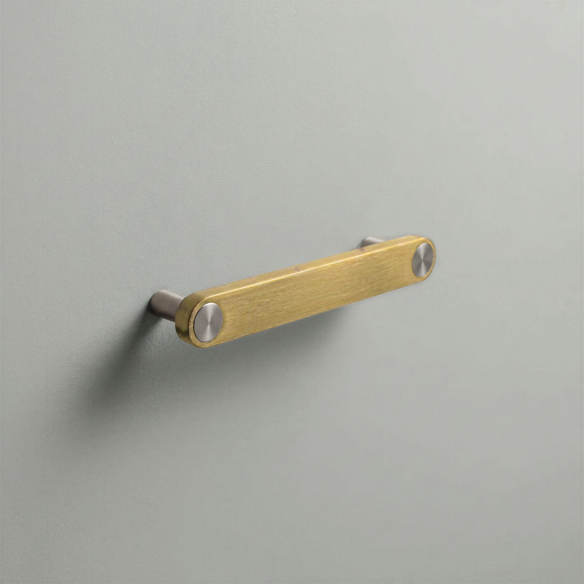 Brass Ensemble Handle in 128mm (5″) Centres size with Brushed Steel button detail by Sloan Roberts.