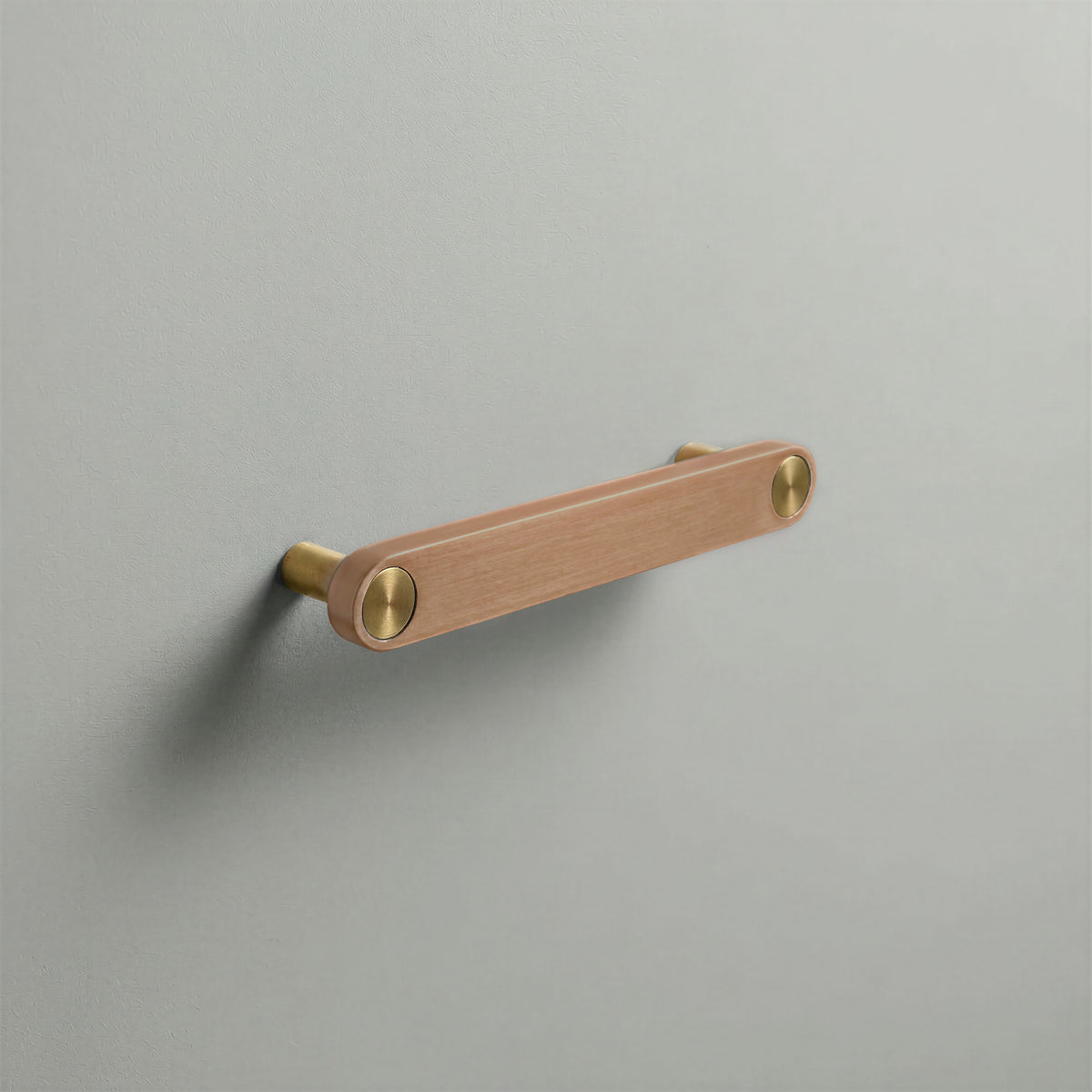 Brushed Copper Ensemble Handle in 128mm (5″) Centres size with Brass button detail by Sloan Roberts.