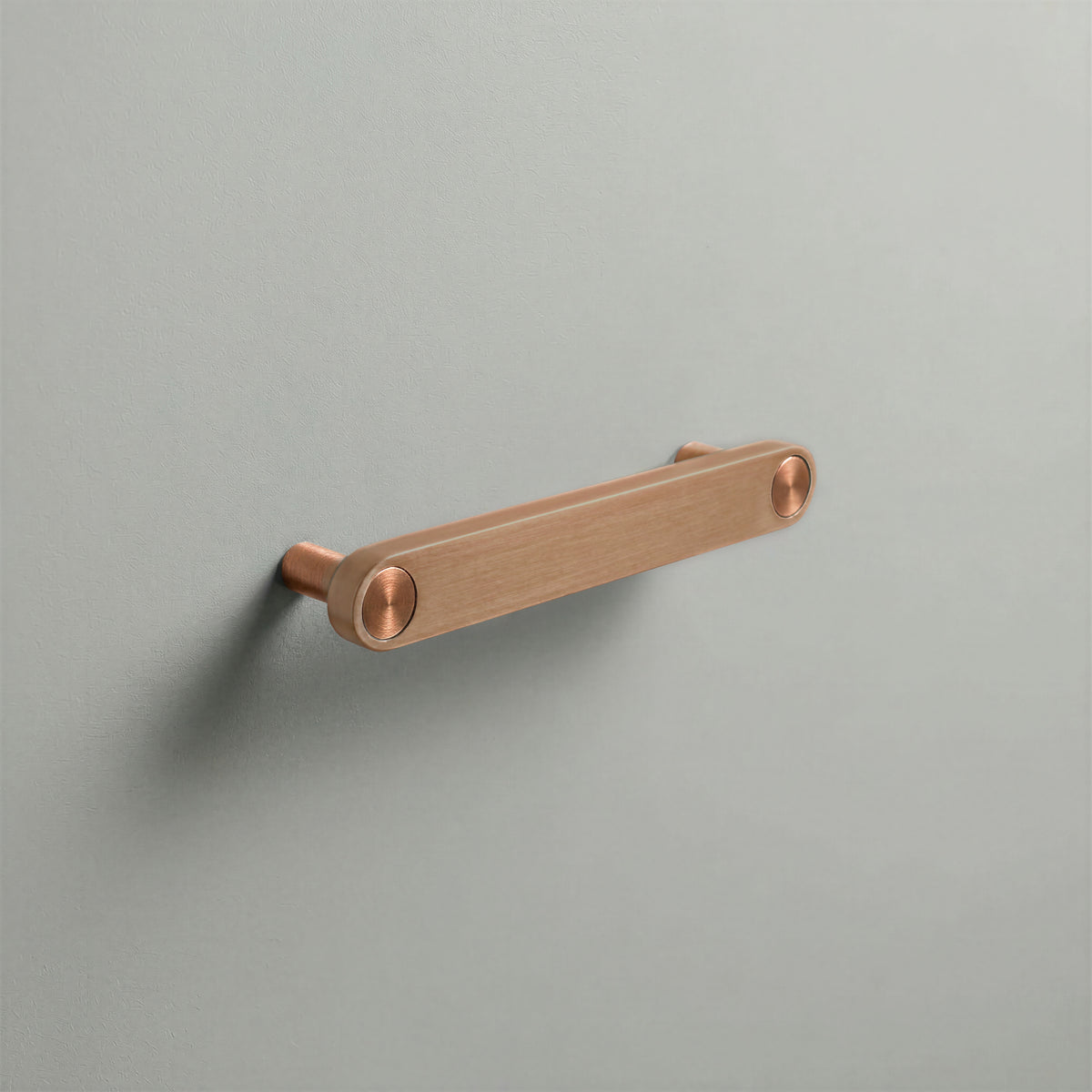 Brushed Copper Ensemble Handle in 128mm (5″) Centres size with Brushed Copper button detail by Sloan Roberts.