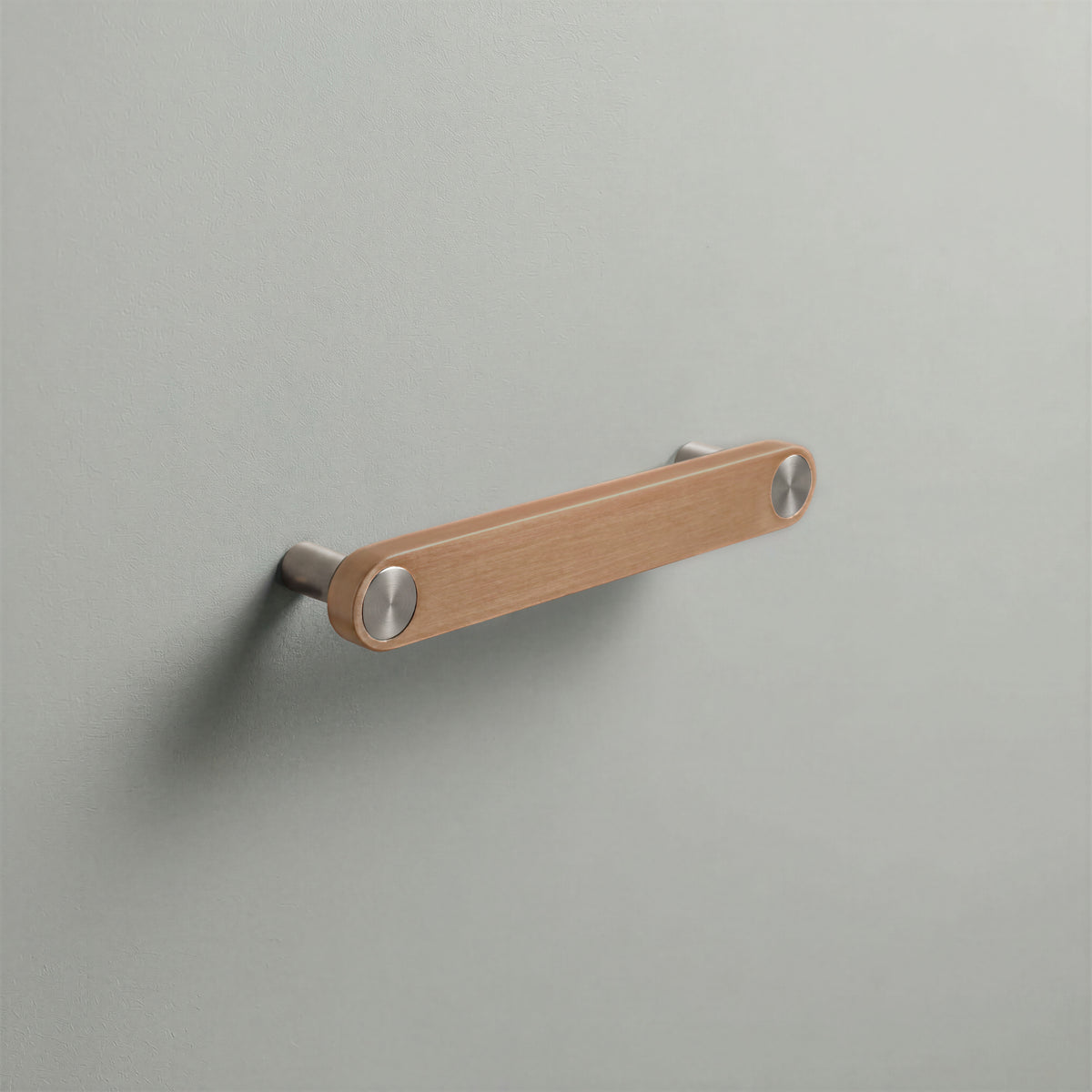 Brushed Copper Ensemble Handle in 128mm (5″) Centres size with Brushed Steel button detail by Sloan Roberts.