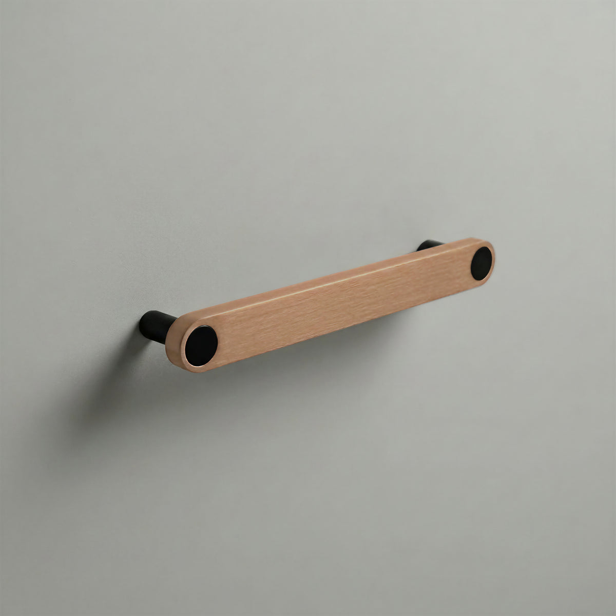 Brushed Copper Ensemble Handle in 160mm (6¼″) Centres size with Matte Black button detail by Sloan Roberts.