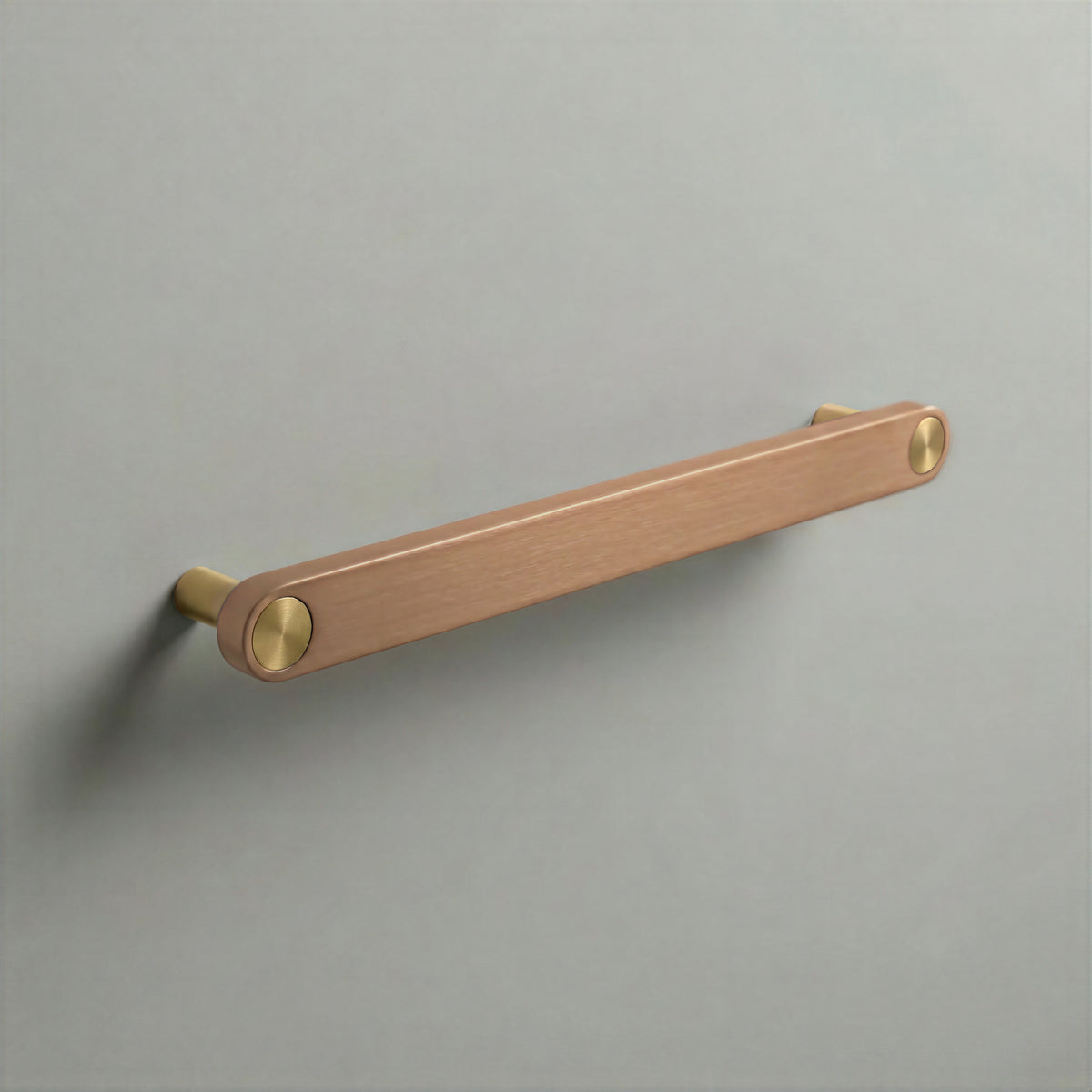 Brushed Copper Ensemble Handle in 192mm (7½″) Centres size with Brass button detail by Sloan Roberts.