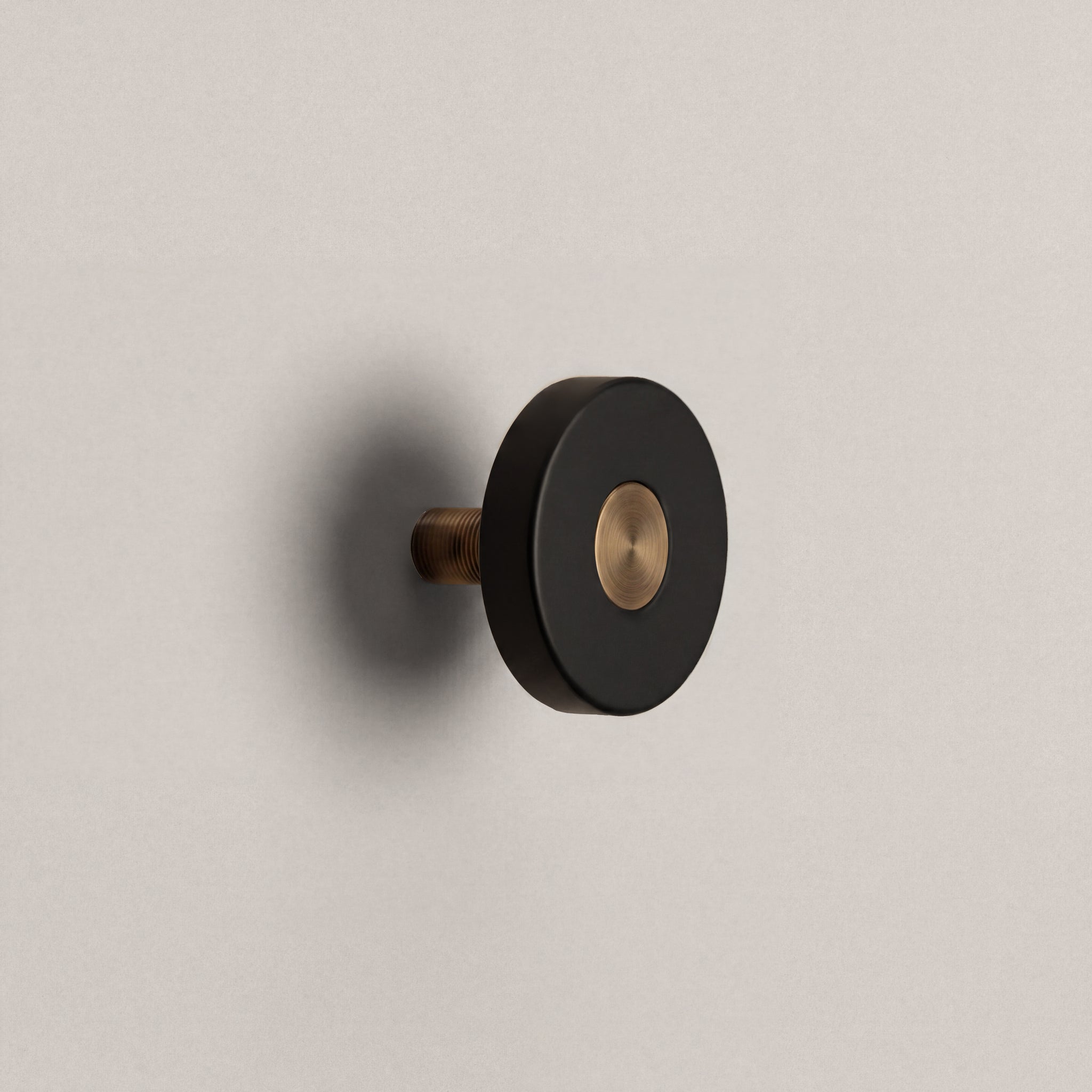 Matte Black Ensemble Handle in Knob size with Aged Bronze button detail by Sloan Roberts.