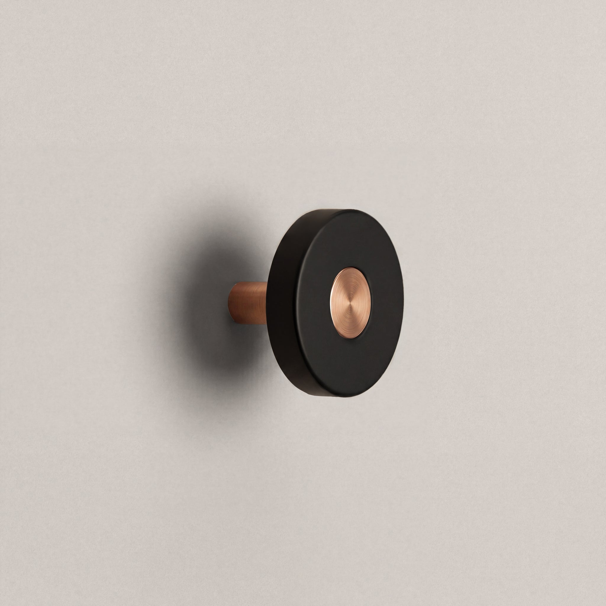 Matte Black Ensemble Handle in Knob size with Brushed Copper button detail by Sloan Roberts.