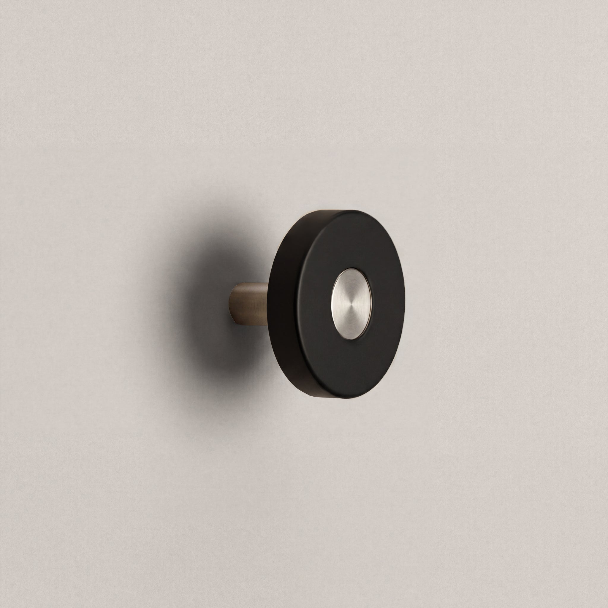 Matte Black Ensemble Handle in Knob size with Brushed Steel button detail by Sloan Roberts.