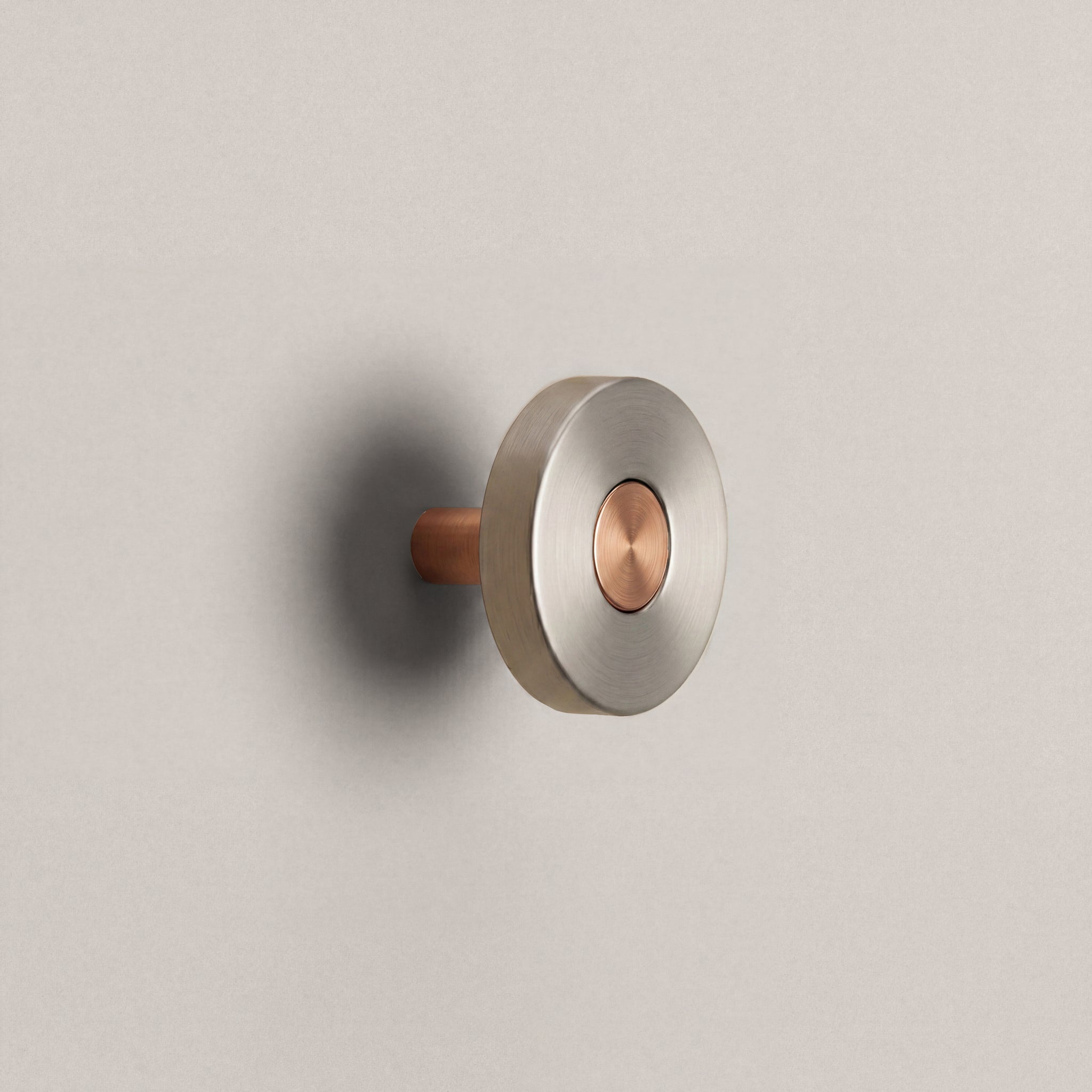 Brushed Steel Ensemble Handle in Knob size with Brushed Copper button detail by Sloan Roberts.