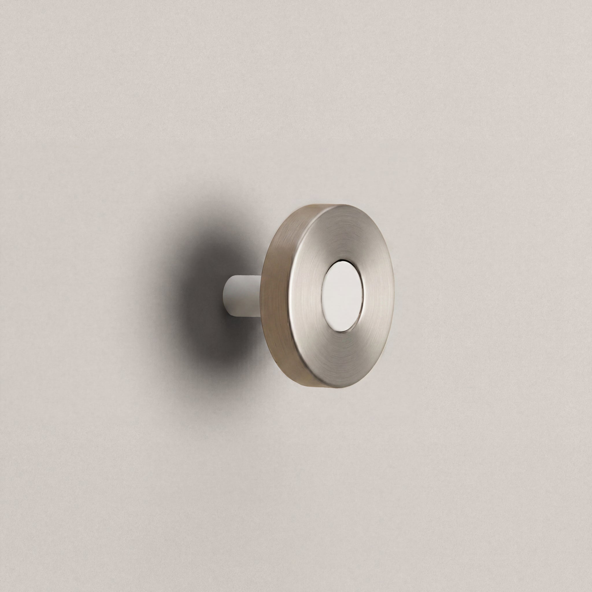 Brushed Steel Ensemble Handle in Knob size with Matte White button detail by Sloan Roberts.